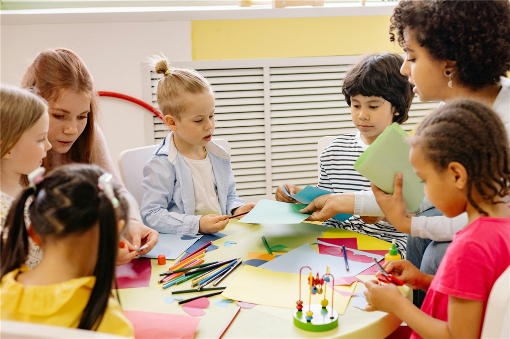 teachers and children at table